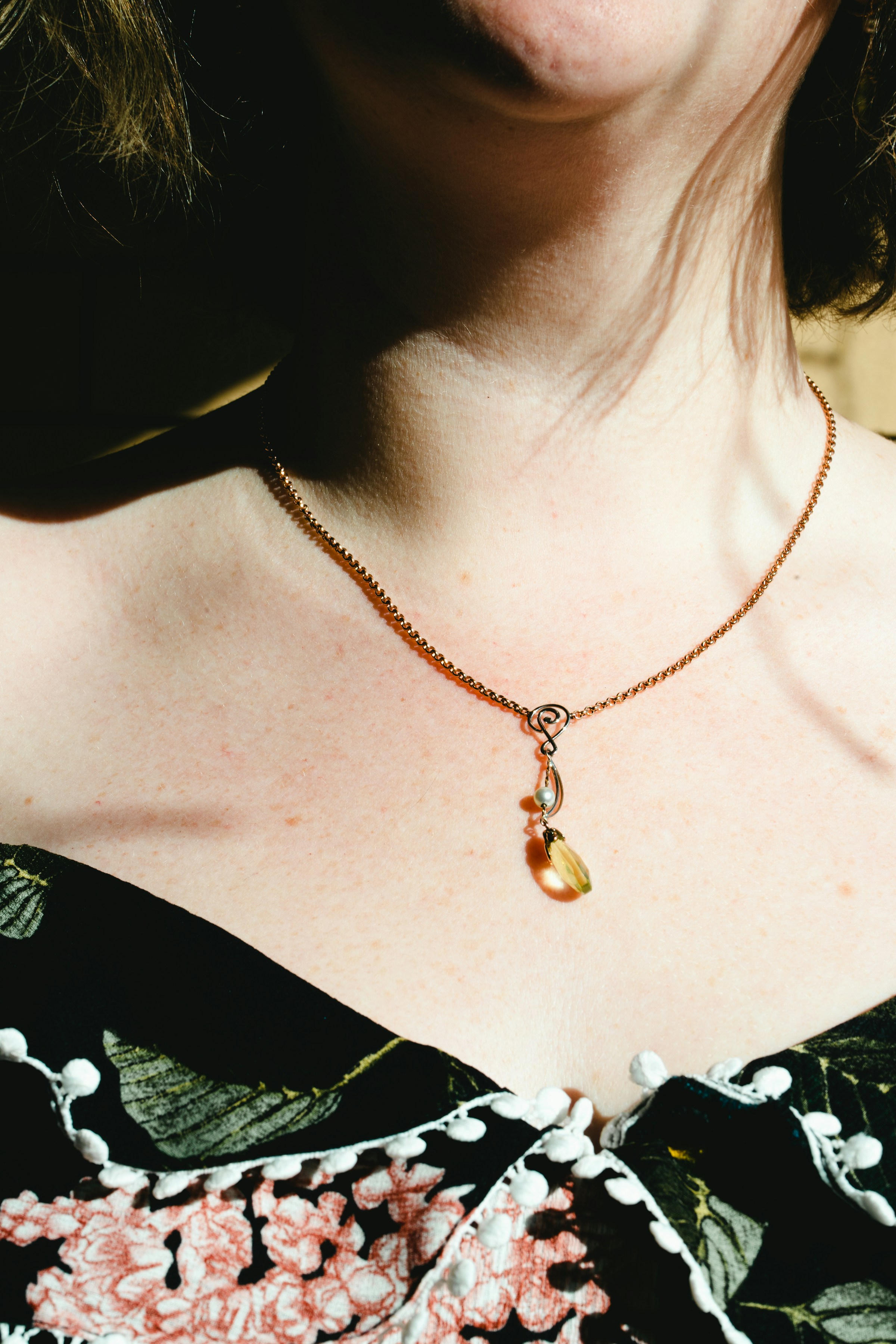 Editorial model displaying Calytris moss agate and pearl jewelry
